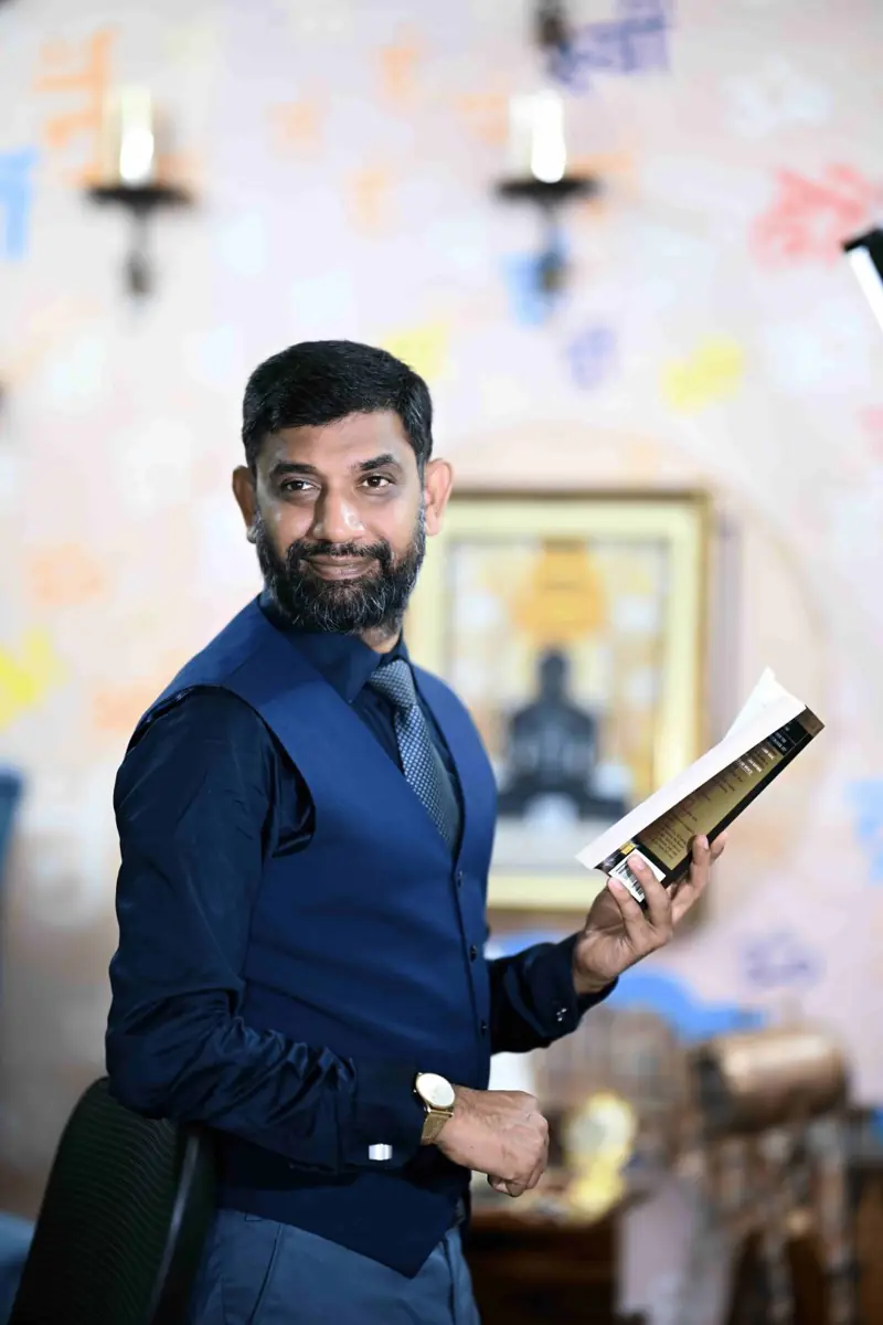 Saurabh Jain, best corporate trainer in Jaipur, holding a self-help book